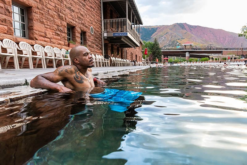 Man Relaxing at the Grand Pool's Edge at Glenwood Hot Springs Resort
