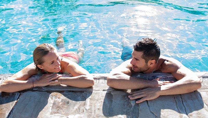 Couple with Elbows Up on Edge of Pool at Glenwood Hot Springs Resort