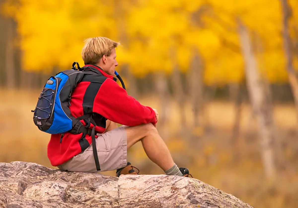 Hiker Stopped for Water With Fall Leaves Behind | Glenwood Hot Springs Resort