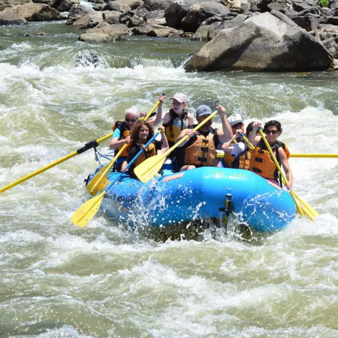 Group Paddling Through White Water Rapids in Glenwood Canyon near Glenwood Hot Springs Resort