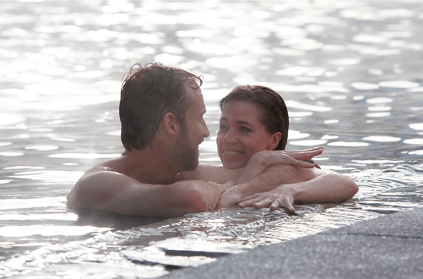 Couple together in water at edge of pool at Glenwood Hot Springs Resort