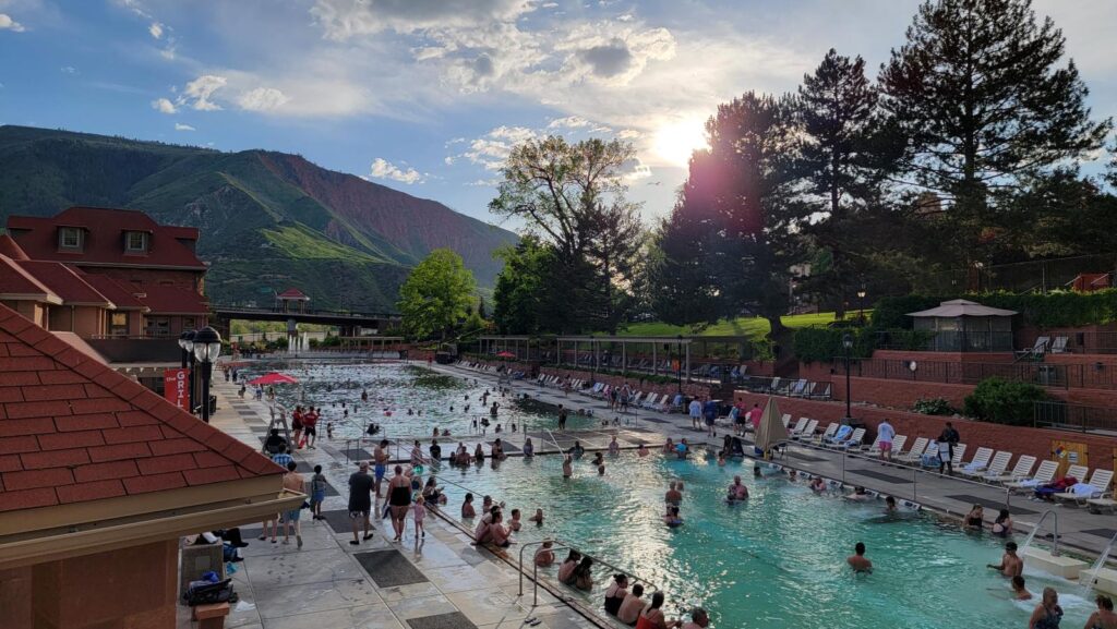 View over the Therapy and Grand Pools as the sun sets at Glenwood Hot Springs Resort