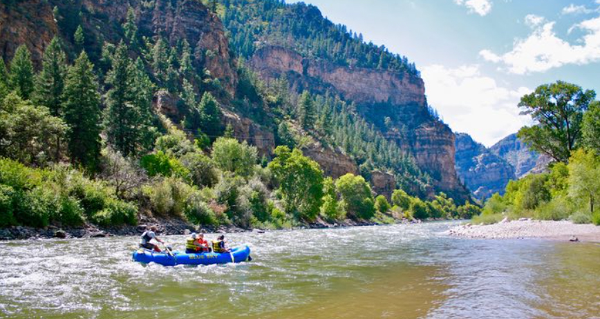 Blue raft going through Glenwood Canyon near Glenwood Hot Springs Resort