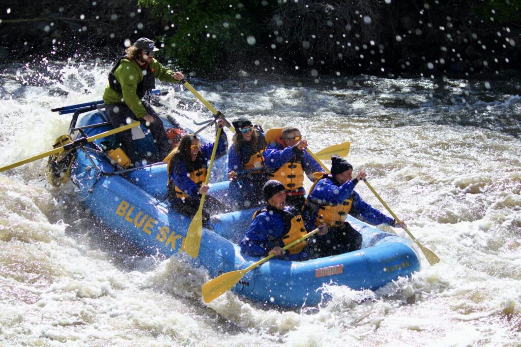 Rowers and guide in raft going through rapids near Glenwood Hot Springs Resort