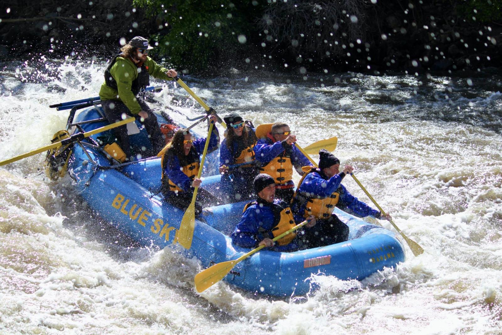 Rowers and guide in raft going through rapids near Glenwood Hot Springs Resort