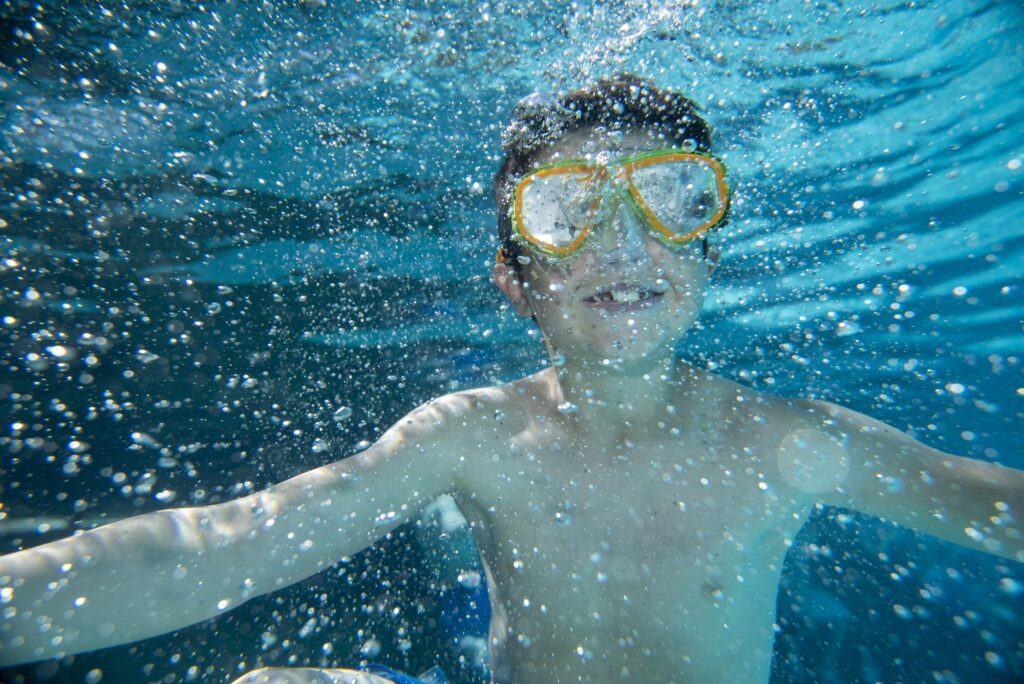 Boy Underwater with Goggles at Glenwood Hot Springs Resort