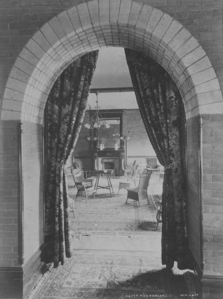 Arched entryway into parlor with a fireplace in the history Stone Bath House at Glenwood Hot Springs Resort